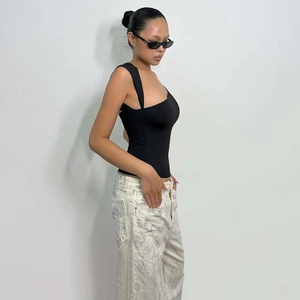 Detail view of black asymmetric single shoulder strap slim fit tank top for women