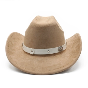 Detail of western cowboy hat with suede texture, white leather band and vintage metal buckle