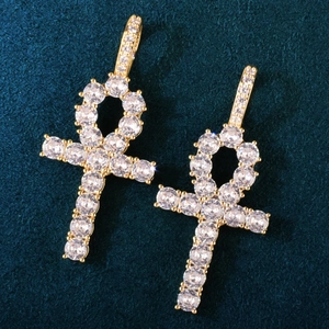 Macro shot of gold-plated copper Ankh pendants with sparkling cubic zirconia on velvet