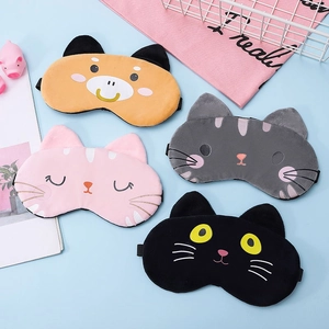 Close-up of four cute plush animal sleep masks in yellow, pink, gray and black colors