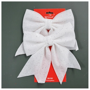 Close-up of two white glitter bow decorations for Christmas trees and festive gift wrapping