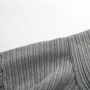 Macro shot of gray ribbed knit fabric texture on an off-shoulder loose sweater