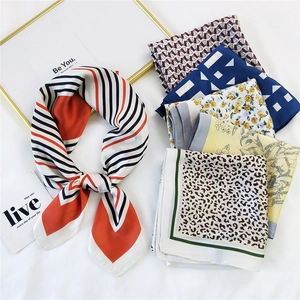 Elegant collection of printed silk scarves featuring geometric and floral patterns