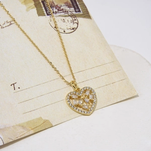 Elegant gold heart pendant necklace with shimmering cubic zirconia on an O-chain