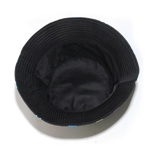 Detail view of the black cotton bucket hat featuring interior lining and brim stitching