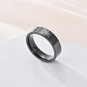 Close-up of black titanium steel ring featuring detailed spider web pattern engraving