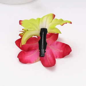 Detail of bohemian red-pink faux orchid hair clip showing secure back crocodile clip