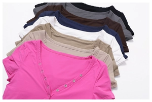 Flat lay of multiple colorful V-neck yoga t-shirts with stylish button details