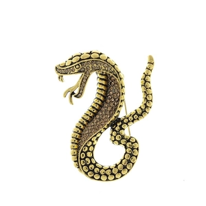Detailed view of vintage gold snake brooch with textured scales and sparkling rhinestones