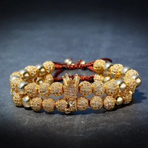 Luxurious double-layer gold beaded bracelet with crown and skull charms on brown cord