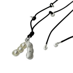 Peanut-shaped silver pendant necklace with three white pearls on black cord