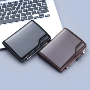 Men's tri-fold leather wallet with 13 card slots and zipper pocket by a laptop