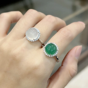 Close-up of white and green chalcedony rings with diamond accents on model hand
