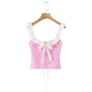 Detail of pink plaid top featuring delicate lace trim and a sweet pink bow accent