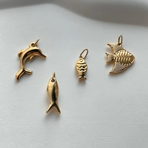 Detailed view of four golden stainless steel marine animal pendants for DIY jewelry making