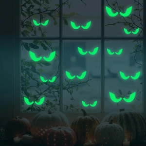 Glow-in-the-dark Halloween monster eyes window decals on glass with spooky pumpkin night background