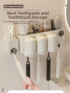 Detail view of wall-mounted cream white toothbrush holder with magnetic cups and dispenser