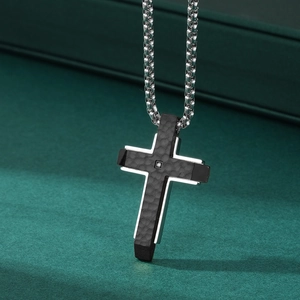 Two-tone titanium steel cross necklace with hammered texture and a single small diamond