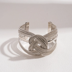 Detailed macro view of the intricate silver woven metal chain and central knot design