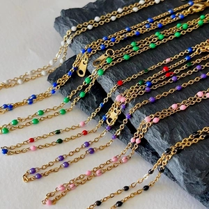 Colorful drip glaze beaded necklace in 18k gold plated stainless steel on rock background