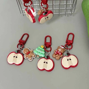 Cute Christmas keychain set with gingerbread man, apple, and tree charms on red metal clips