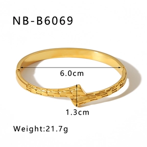 Detailed view of 18K gold plated asymmetric cuff bracelet with geometric textures
