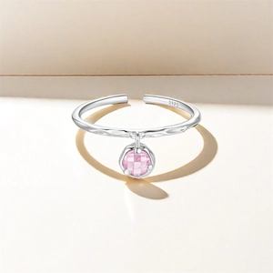 Macro shot of S925 sterling silver open ring with a pink faceted zircon pendant