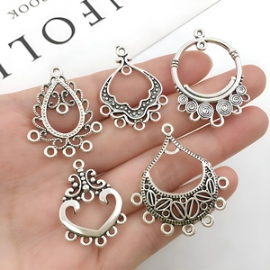Close-up of five silver vintage alloy connectors for DIY earring jewelry making