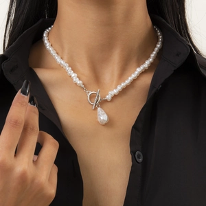 Baroque irregular pearl necklace with T-bar clasp shown on model with black shirt background