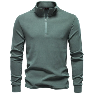 Detail of soft green fleece texture and half-zip collar on men's thermal pullover