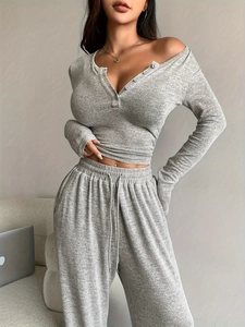 Detail of gray marl ribbed knit lounge set featuring V-neck button top and drawstring pants