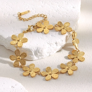 Close-up of 18K gold plated daisy bracelet with brushed texture and lobster clasp