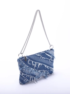 Detail of distressed denim patchwork crossbody bag with frayed fringe and silver chain strap