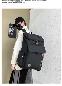 Detailed side view of large black fitness backpack with orange zipper accents on a model