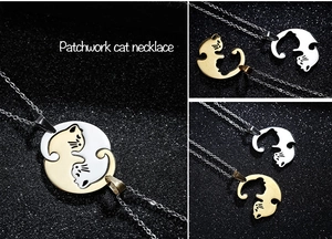 Detailed close-up of interlocking gold and silver cat pendants on a black starry background