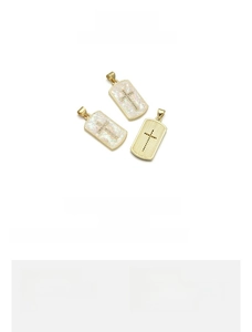 Detail view of 18K gold plated copper cross pendant with colorful opal inlay effects