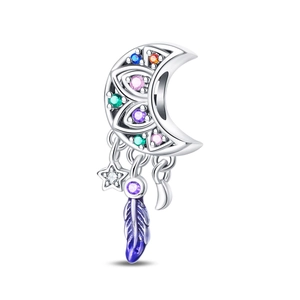 Macro detail of crescent moon charm with colorful gems and hanging feather and star charms