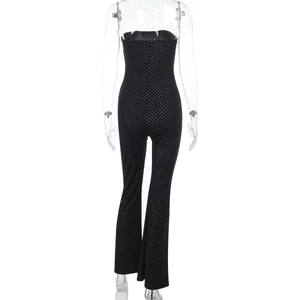 Detail view of the black and white polka dot tube top jumpsuit showing slim fit waist