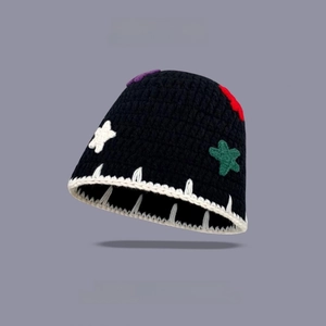 Detail of black knit bucket hat featuring colorful star patches and contrast stitching