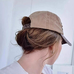 Detail view of washed beige baseball cap with special ponytail cutout for women