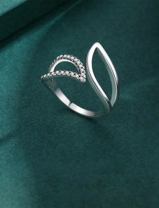 Macro shot of 925 silver leaf ring with micro-pave zircons and asymmetric open design