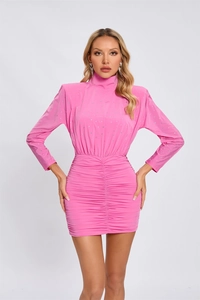 Close-up of pink sequined fabric texture and gathered ruching detail on the dress