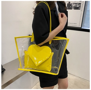 Macro detail of yellow transparent jelly tote bag with heart-shaped inner pouch