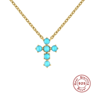 Gold 925 sterling silver necklace with a geometric turquoise cross pendant on white background