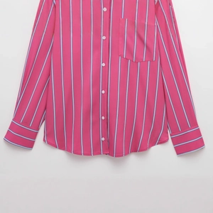Relaxed fit fuchsia striped button-down shirt with long sleeves and front pocket