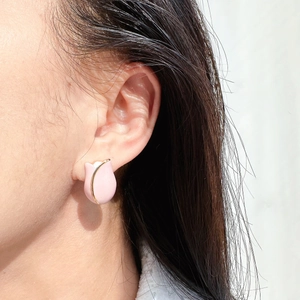 Elegant pink enamel tulip stud earrings with gold plating shown on a model's ear