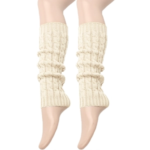 Close-up of beige cable-knit leg warmers showing thick knit texture and elastic cuffs