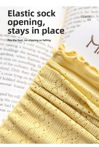Detail of light yellow hollow lace socks showing breathable mesh and elastic wavy cuffs