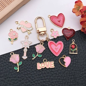 DIY mixed alloy heart pendants and rose charms for jewelry making on leather background