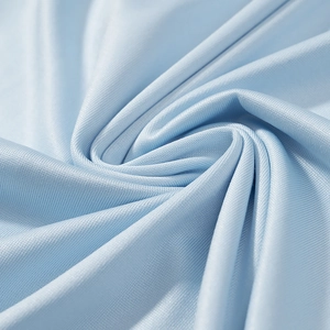Macro shot of light blue mesh knit fabric showing breathable texture and ruffled detail